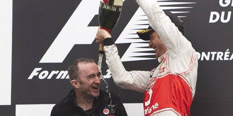 Jenson Button pours champagne on Paddy Lowe after a race in 2011. It was announced that Lowe would stay on as the McLaren Technical Director for at least one more year.