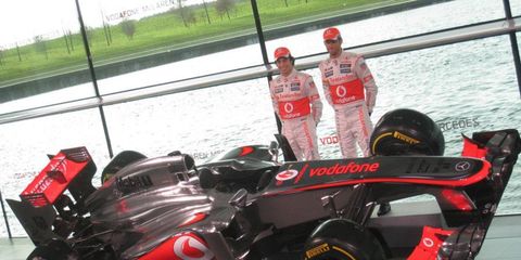 The McLaren MP4-28 and drivers Sergio Perez, left, and Jenson Button.
