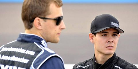 Kyle Larson, right, stands with James Buescher last season. Larson participated in an interview Wednesday about the upcoming season.