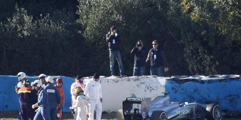 Lewis Hamilton walks away from his car after hitting a wall during Formula One testing on Wednesday.