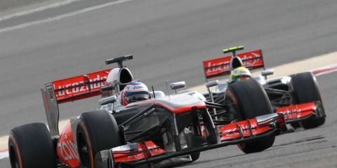 Jenson Button, left, does battle with teammate Sergio P&eacute;rez at the Formula One Bahrain Grand Prix.