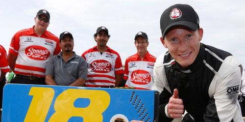 Mike Conway shows off his pole sticker at Belle Isle after winning his first IndyCar Series pole and the first pole for Dale Coyne Racing on Saturday.