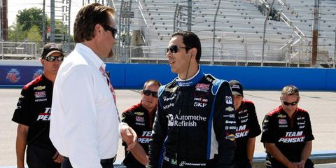 Helio Castroneves, right, talks with IndyCar race director Beaux Barfield prior to his qualifying run at Milwaukee on Saturday.