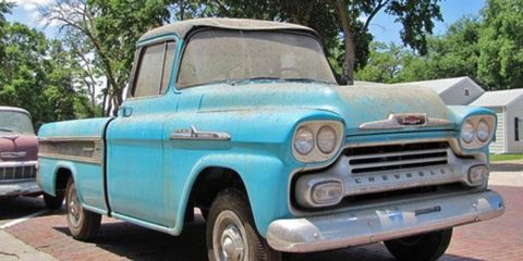 Under decades of grime, a 1958 Chevrolet Cameo pickup with just over one mile on the odometer waits for the right buyer.