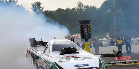John Force held on to the top qualifying spot in NHRA Funny Car at New England Speedway on Saturday. Force will try to make it two event wins in a row on Sunday.