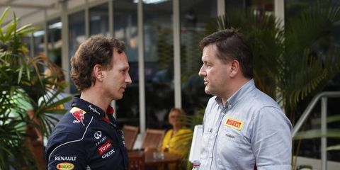 Christian Horner or Red Bull talks with Paul Hembery of Pirelli at a recent race. After Sunday's race in England, Horner spoke out against the tire company.