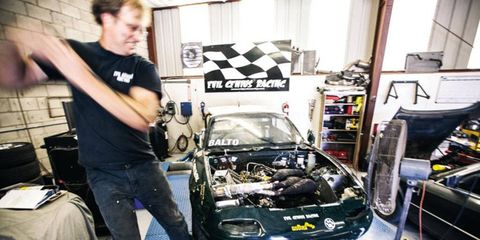 Evil Genius Garage proprietor John Pagel pull-starts Balto, a snowmobile engine-powered Miata.