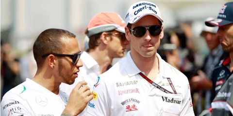Lewis Hamilton, left,  and Adrian Sutil reportedly have had a strained relationship since Sutil's assault trial last year.