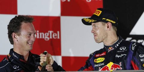 Red Bull driver Sebastian Vettel shares some champaign with boss Christian Horner.