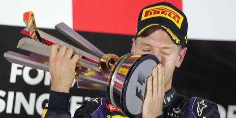 Sebastian Vettel celebrates with the trophy after his Formula One win in Singapore on Sunday.