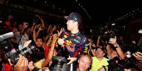 Four-time Formula One champion Sebastian Vettel celebrates with the fans after his win Sunday in India.