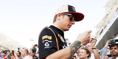 Is it possible that Kimi R&auml;ikk&ouml;nen is sneaking a peak at his bank app on his smart phone to see if that Lotus payment has cleared?