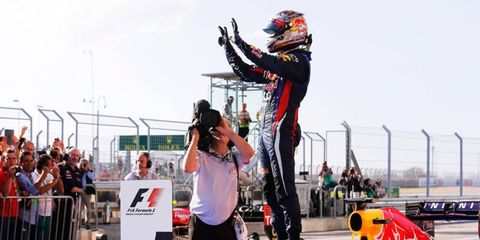 Sebastian Vettel holds up eight fingers to the crowd to signify eight straight Formula One victories.