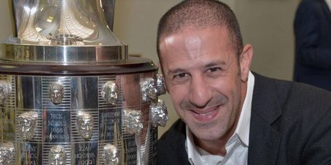 Tony Kanaan shows off his likeness on the Borg-Warner Trophy at the Indianapolis Motor Speedway Museum on Monday.