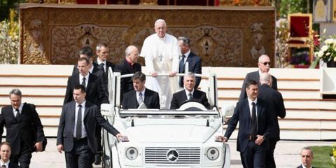 Pope Francis I in his Mercedes-Benz popemobile.