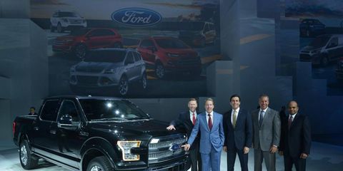 Against the backdrop of a black Ford F-150, these executives automatically become more attractive.