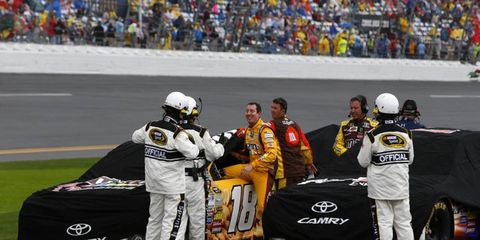 NASCAR Sprint Cup driver Kyle Busch gets out of his car on Sunday after the Daytona 500 was halted due to rain.