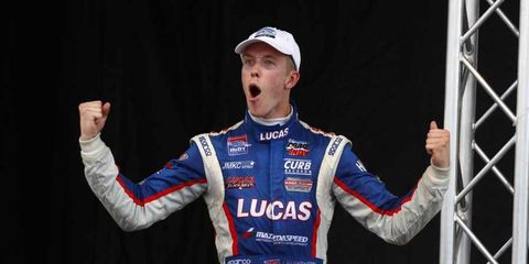 Jack Hawksworth celebrates on the podium after a 2013 Indy Lights race in Baltimore.