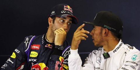 Daniel Ricciardo (left) and Lewis Hamilton (right) share a few words during Saturday's Formula One press conference.