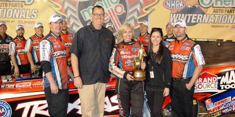 Sarah Adams, standing to the right of Courtney Force, is a public relations pro with John Force Racing.