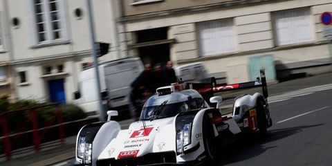The Audi R18 e-tron quattro World Endurance Championship car races down the streets of Le Mans on Tuesday.