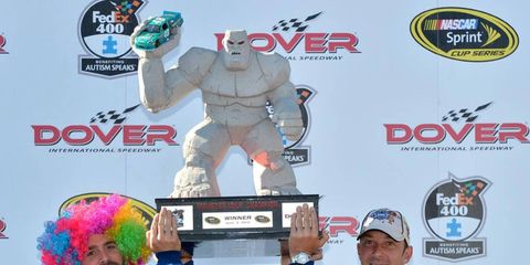 Jimmie Johnson and crew chief Chad Knaus lift up Johnson's Dover trophy from 2012. The trophy is one of the most popular in NASCAR, but they are so large, they aren't easy to display.