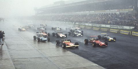 A wet start to the 1968 German Grand Prix at the Nurburgring. Racer Chris Amon in the Ferrari 312, leads Graham Hill, Jochen Rindt, and Jackie Stewart.