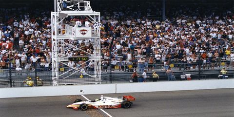 Kenny Brack crosses the finish line at the 1999 Indy 500. Robby Gordon looked as if he would win, but ran out of fuel with a bit more than a lap remaining. Brack took the lead and never let it go.