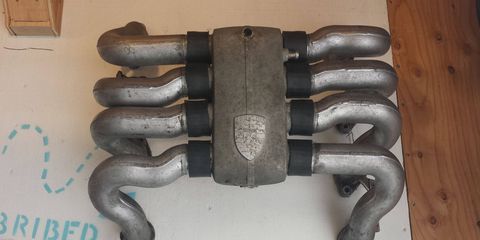 It needs a good polishing and some better hoses, but I couldn't wait for those things before bolting this 928 intake to my garage wall.