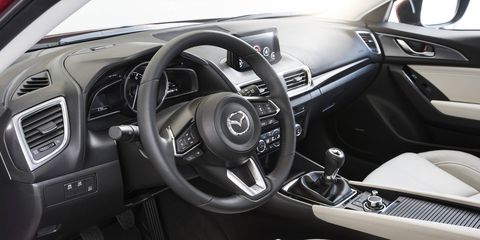 The 2017 Mazda 3 Grand Touring gets perforated leather seats, full-color active driving head-up display, an analog tach and digital speedometer.