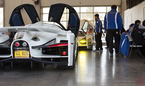 The 2018 SCG 003s getting ready to head out on to the Monticello track with the crew in the garage.