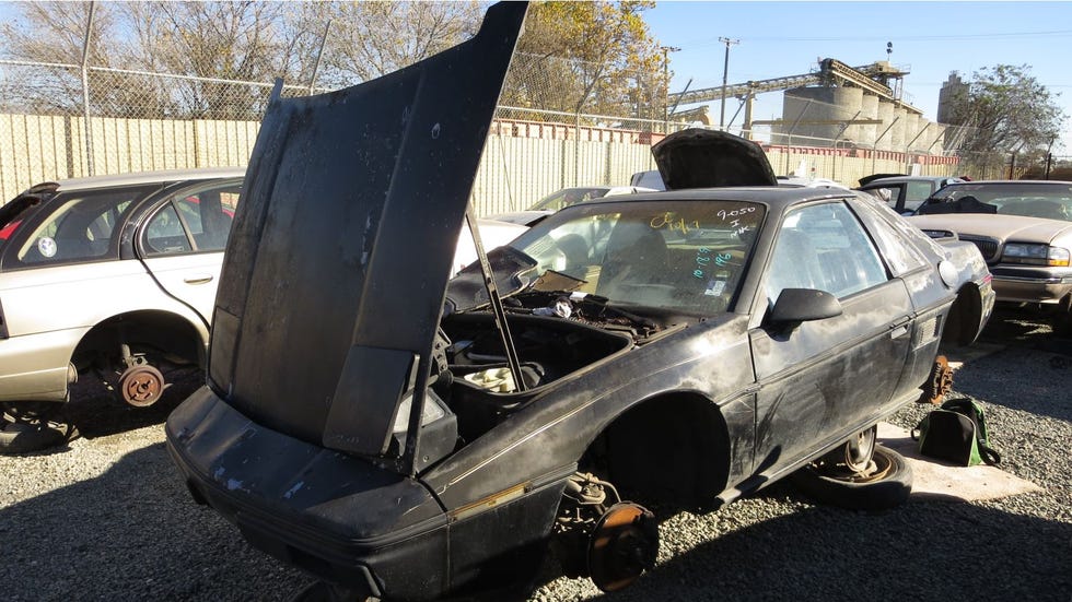 A 1985 Pontiac Fiero econo-commuter in a Northern California wrecking yard.