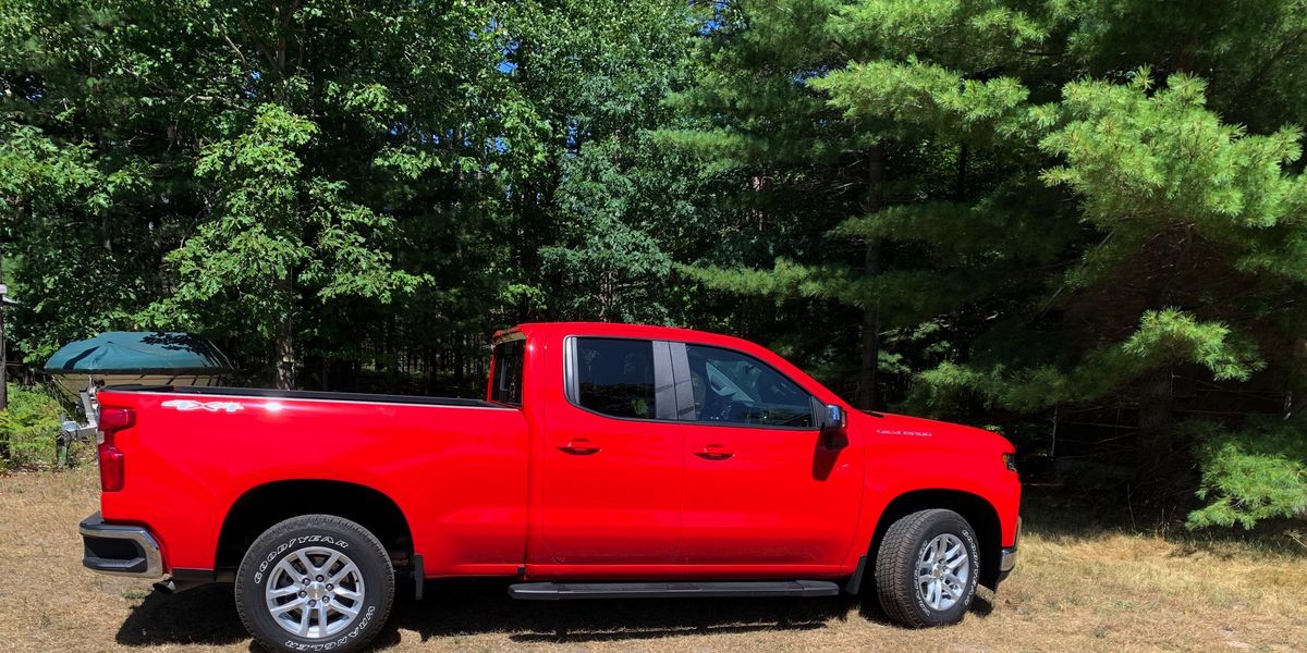 The 2019 Chevrolet Silverado in profile. In the background, the boat it will soon be burdened to tow for nearly 250 miles.

