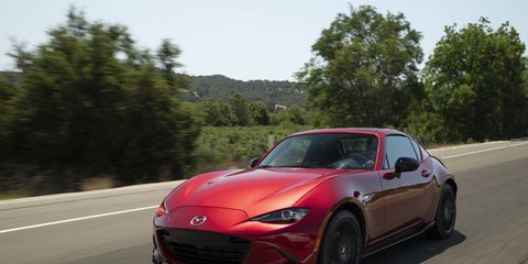 MAZDA MX-5 Miata -- For 2019, the Mazda MX-5 Miata (RF model shown) got a new engine with considerably more power. Mazda bumped the MX-5’s peak output by 26 hp for a total of 181. Torque nudges up 3 lb-ft to 151. Despite the extra oomph, the “slow car fast” mantra still fits. The MX-5's suspension setup happily remains the same. Upfront is a pair of double wishbones and in back is a multilink setup. It’s still softly sprung, so the body leans into corners as lateral load builds. But adding power doesn’t undermine the Miata’s core mission of letting you drive the car to its limit, which is mercifully low enough to avoid a lasting jail sentence. It just feels right.