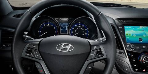 The 2013 Hyundai Veloster turbo includes a leather-wrapped steering wheel and a navigation center.
