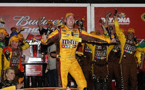 Kyle Busch celebrates after winning the Bud Shootout. He won despite being involved in three crashes.