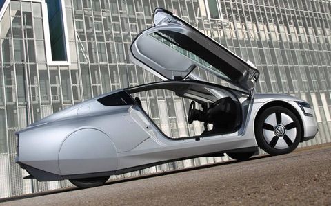 A side view of the Volkswagen XL1 with the doors open.