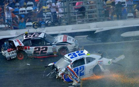 Brad Keselowski (22) gets by Kyle Larson (32) after Larson's car breaks apart after colliding with the catch fence at Daytona on Saturday.