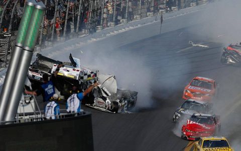 The checkered flag flies as cars careen out of control at Daytona on Saturday.