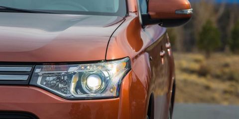 Projector lenses reveal the HID headlights on the 2014 Mitsubishi Outlander.
