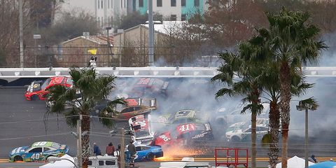 Contact between the cars in Turn 3 sent Menard spinning and caused a massive pileup behind him, damaging 17 of the 20 cars to varying degree