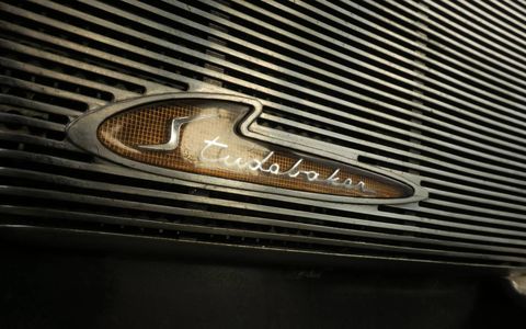 The radio speaker emblem is one of many interesting styling touches inside this car.