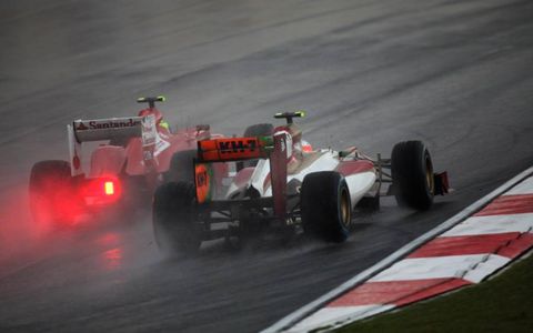 2012 Malaysian Grand Prix: Felipe Massa, Ferrari F2012, passes Narain Karthikeyan, HRT F112 Cosworth.