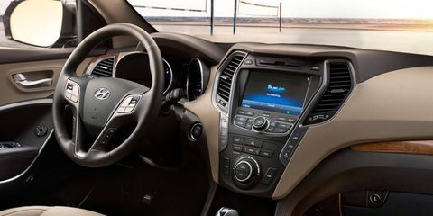 The interior of the 2013 Hyundai Santa Fe Sport is equipped with an optional 8-inch touchscreen, heated steering wheel, and leather-wrapped interior.