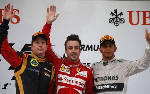 Podium finishers Kimi Raikkonen (left), Fernando Alonso (center) and Lewis Hamilton wave to the crowd in China on Sunday.