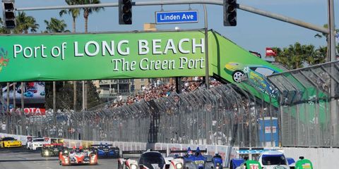 The No. 16 Dyson Lola-Mazda and the No. 6 Aston Martin head for the green flag in Long Beach, Calif., on April 16. Photo by: Dan R. Boyd LAT