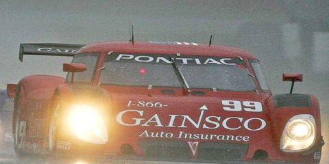 The #99 Pontiac Pontiac Riley of Jon Fogarty and Alex Gurney races in the rain.