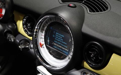 The Mini Connected app resides on the user's iPhone and facilitates communication with the vehicle's dash interface.