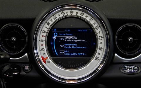 The Mini Connected app resides on the user's iPhone and facilitates communication with the vehicle's dash interface.
