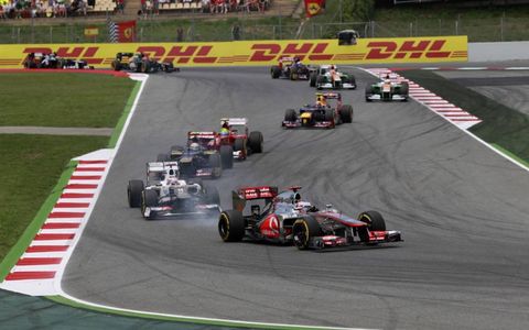 2012 Spanish Grand Prix: Jenson Button, McLaren MP4-27 Mercedes, leads Kamui Kobayashi, Sauber C31 Ferrari, Jean-Eric Vergne, Toro Rosso STR7 Ferrari, and Felipe Massa, Ferrari F2012.